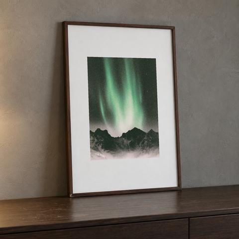 30 × 40 cm northern lights print from Igor Grushko shown in a thin walnut display frame leaning on a wood console.